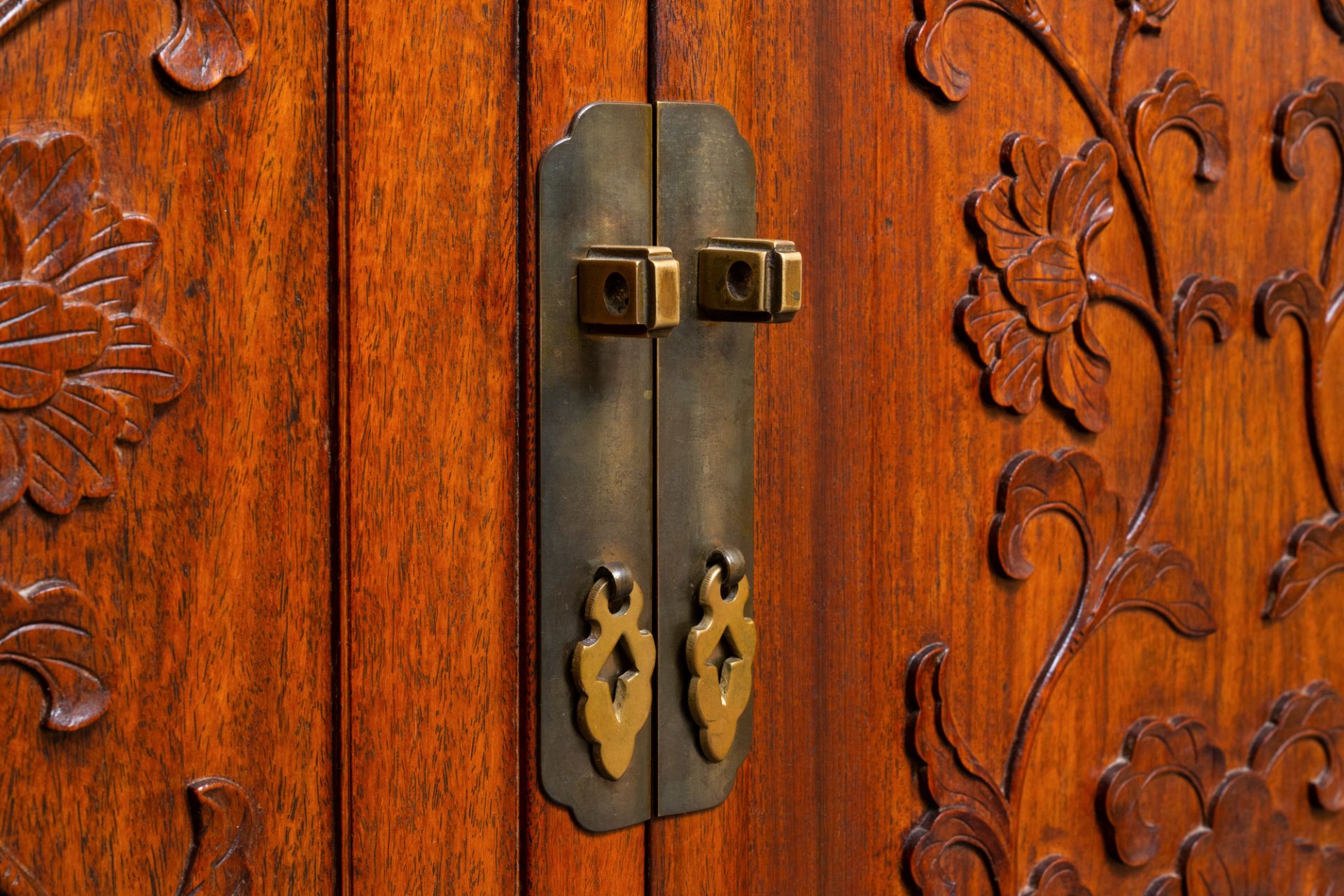 A Chinese wooden two-door cupboard with carved floral panels, 19th C. - Image 3 of 12