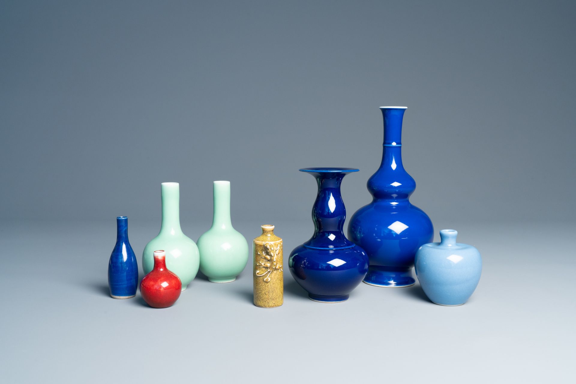 Seven various Chinese monochrome vases and a snuff bottle with relief design, 20th C.