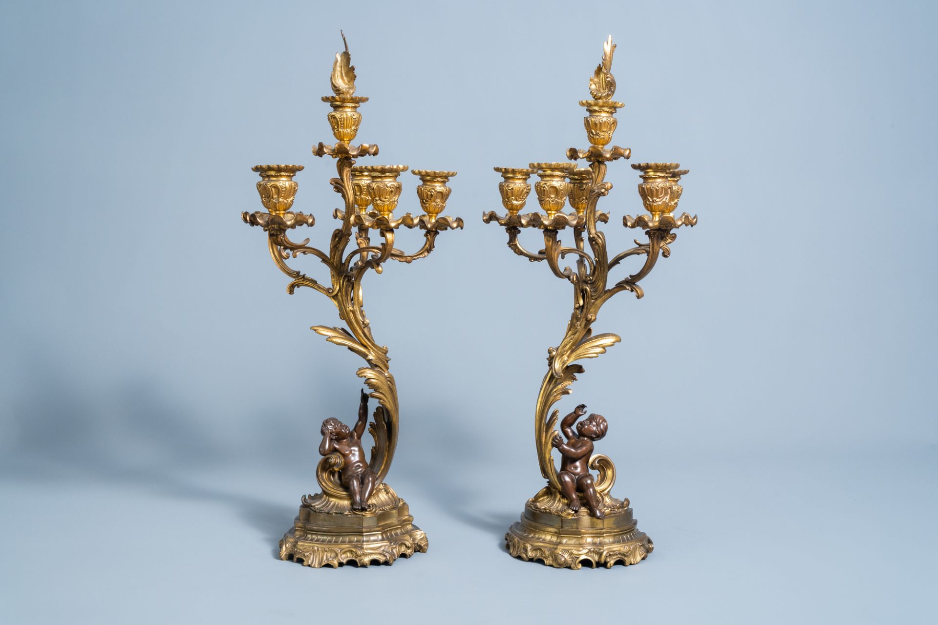 A pair of French gilt and patinated bronze Louis XV style five-light candelabra, 19th/20th C.