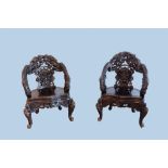 A pair of Chinese or Japanese carved wooden 'dragon' chairs, 19th/20th C.