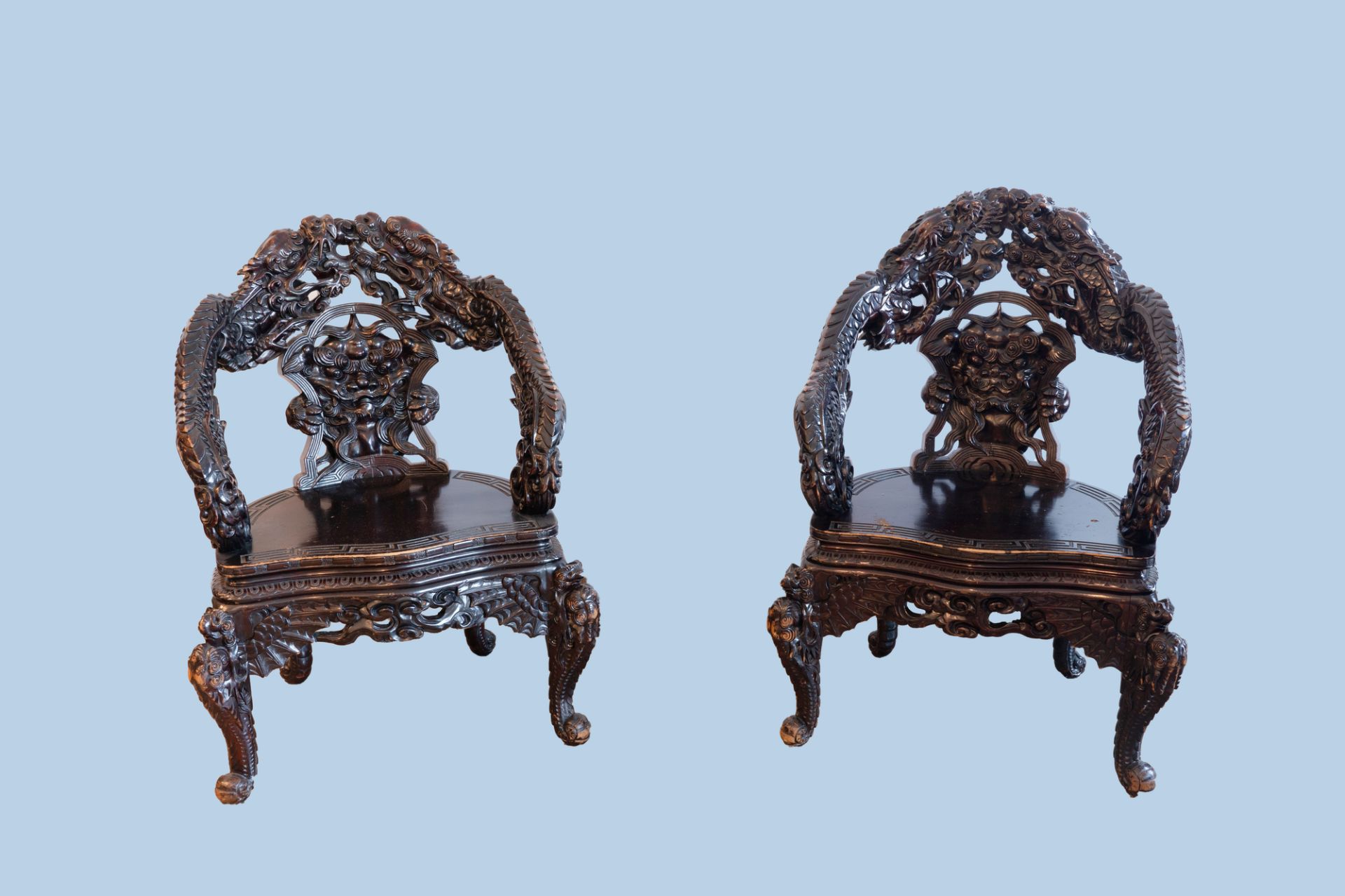 A pair of Chinese or Japanese carved wooden 'dragon' chairs, 19th/20th C.