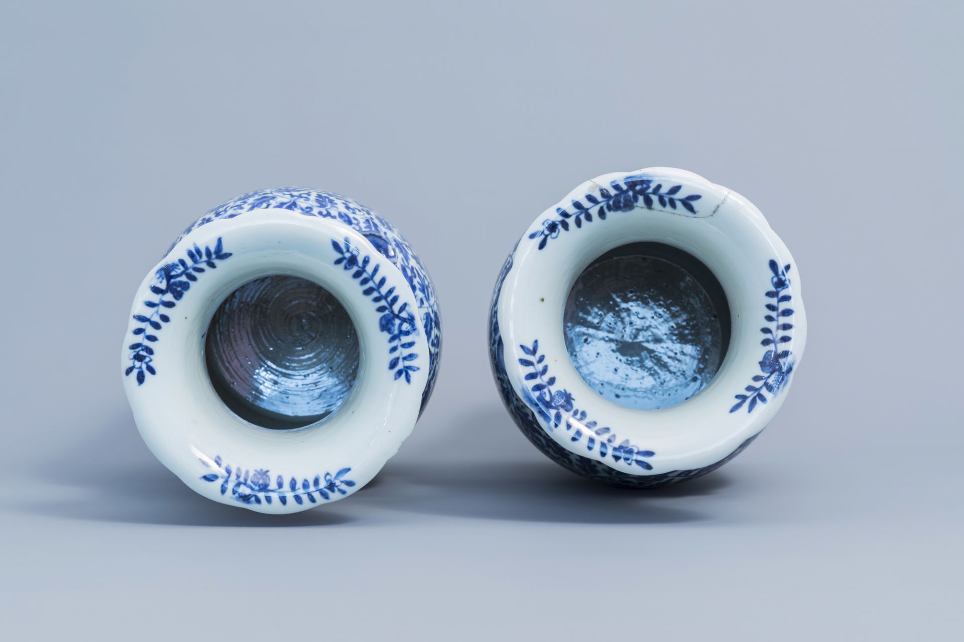A pair of Chinese blue and white 'lotus scroll' vases with relief design, 19th C. - Image 5 of 6