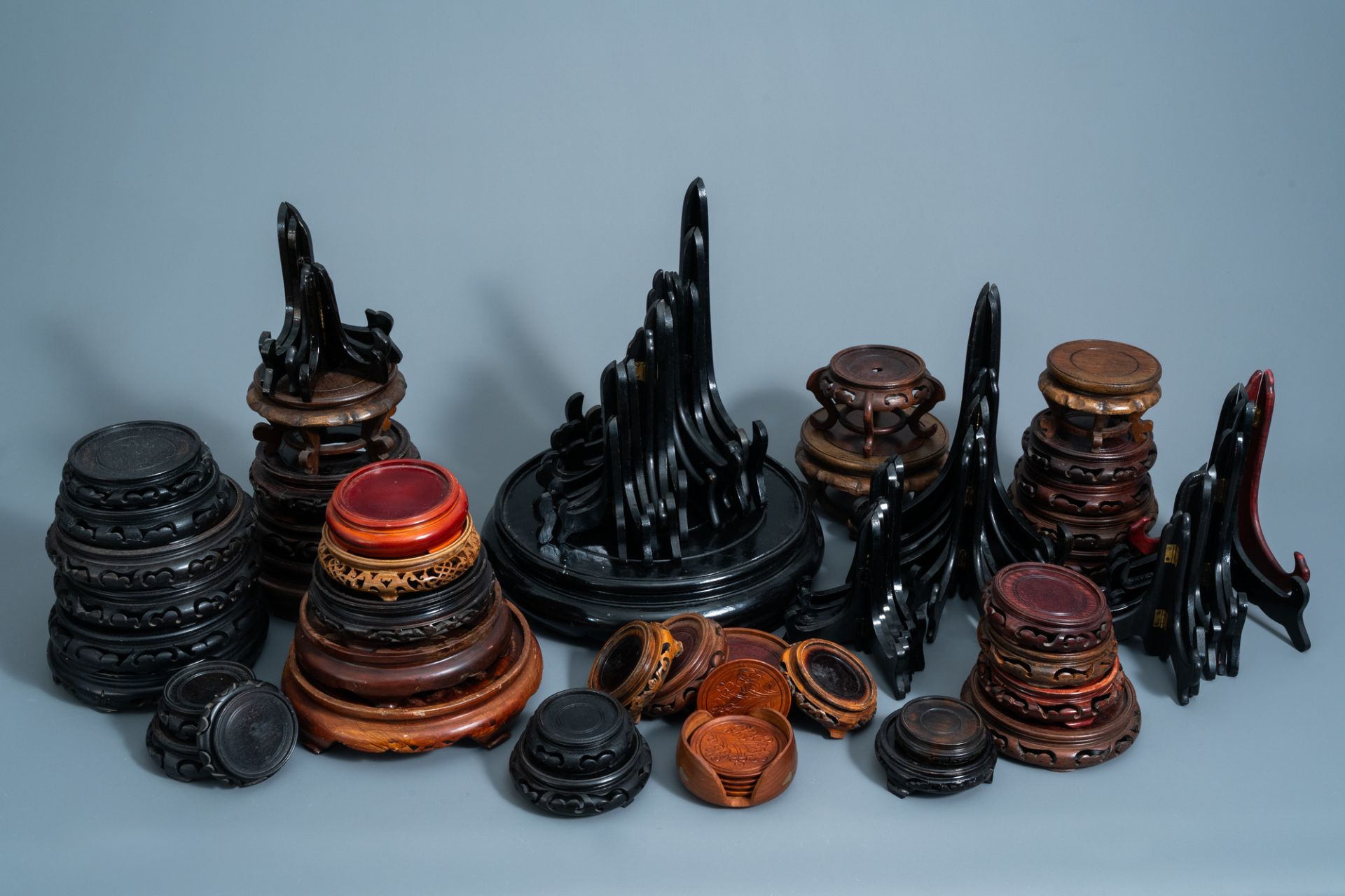 A collection of Chinese carved wooden stands and plate holders, 19th/20th C.