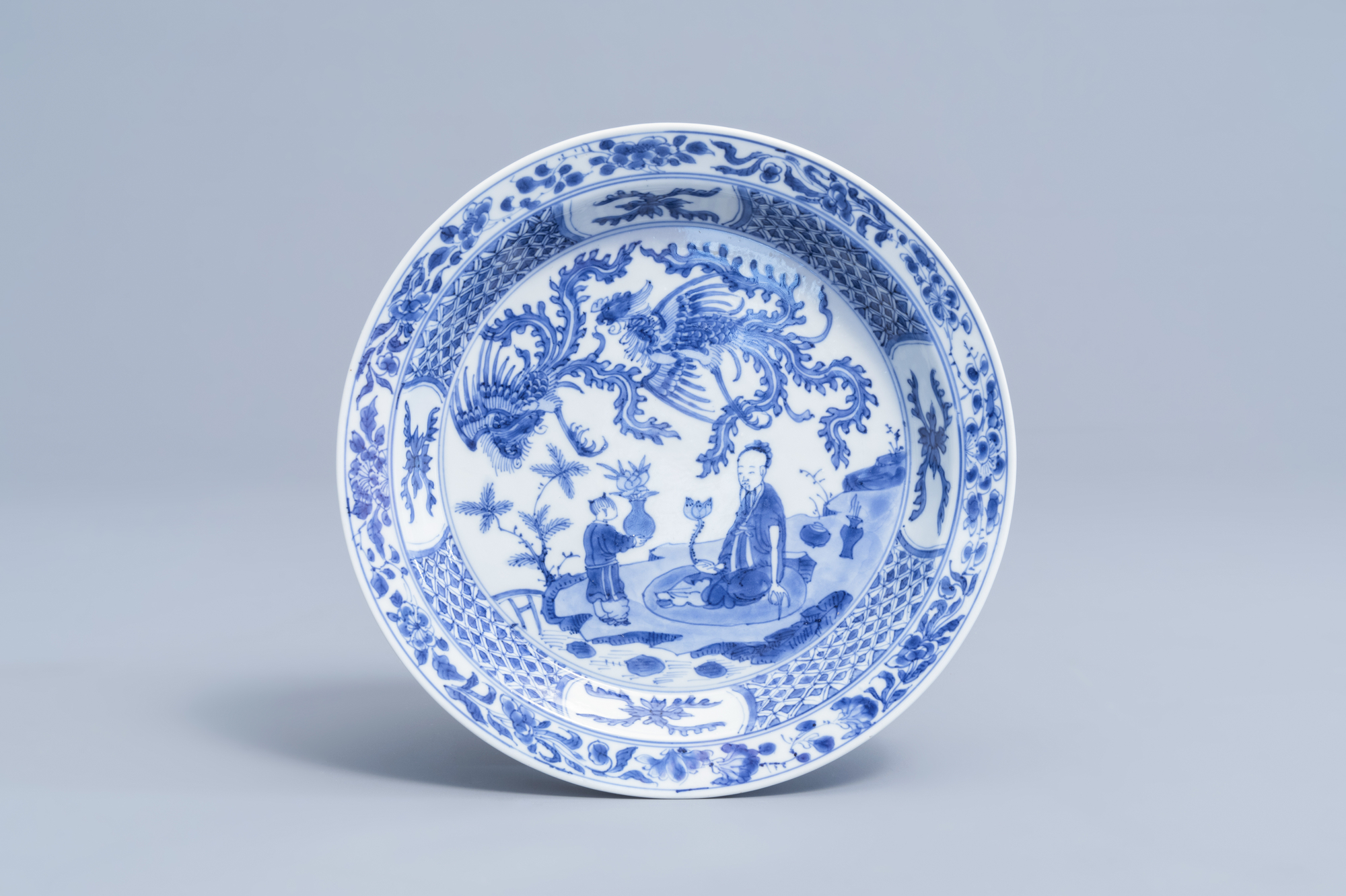 A Chinese blue and white dish with figures and phoenixes in a landscape, Kangxi