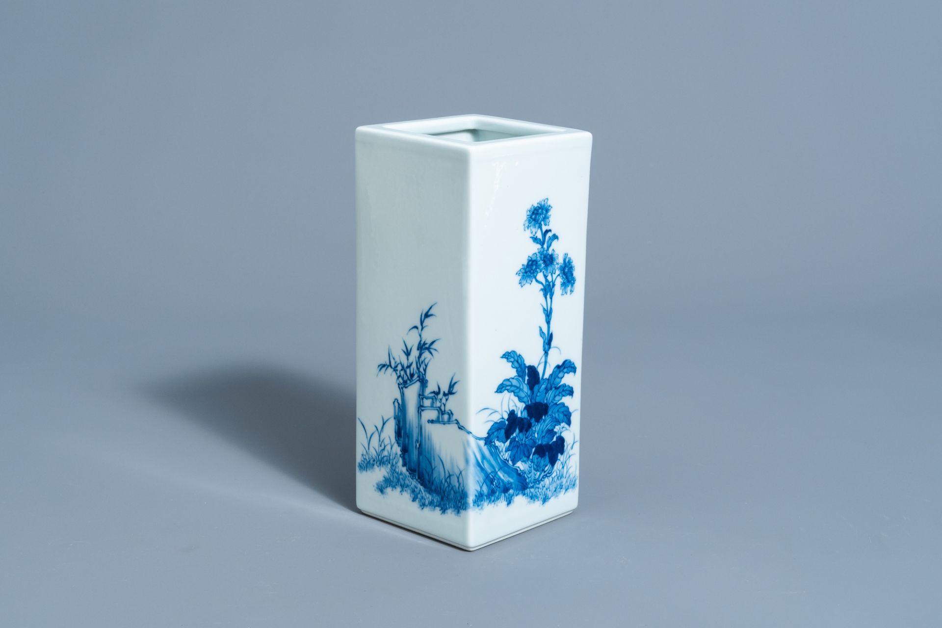 A square Chinese blue and white brush pot with floral design, marked, 20th C.