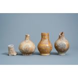 Three German stoneware bellarmine jugs and a neck fragment, 16th/17th C.