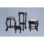 Four Chinese wood stands, one with a marble top, 20th C.