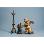 A patinated bronze pricket candlestick, a gilt wooden angel and a polychrome painted dummy board wit