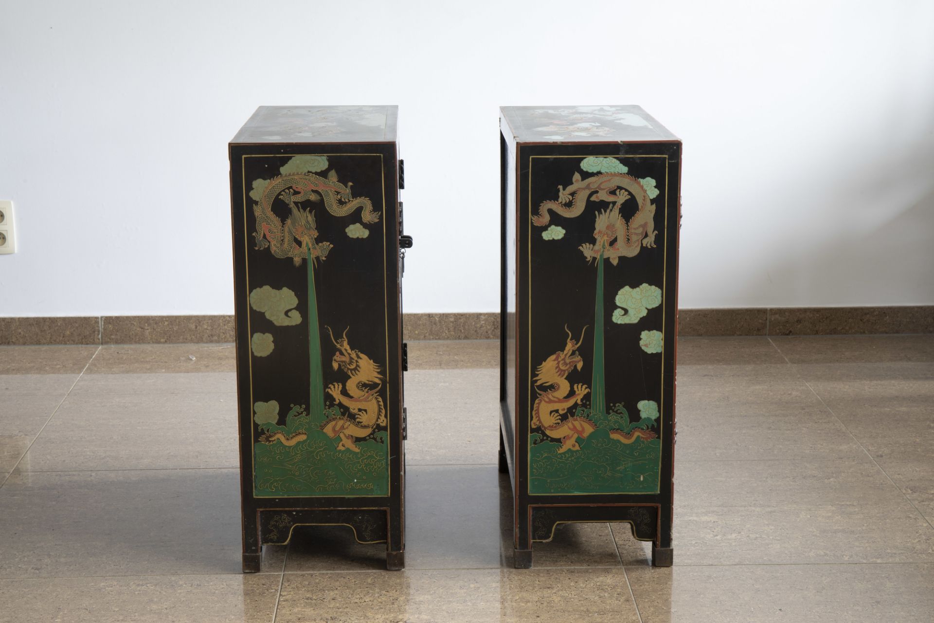 A pair of Chinese black lacquered wooden 'dragons chasing the pearl' two-door cabinets, 20th C. - Image 3 of 7