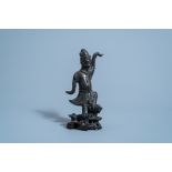 A Chinese bronze figure of a dancer on wooden stand, Ming