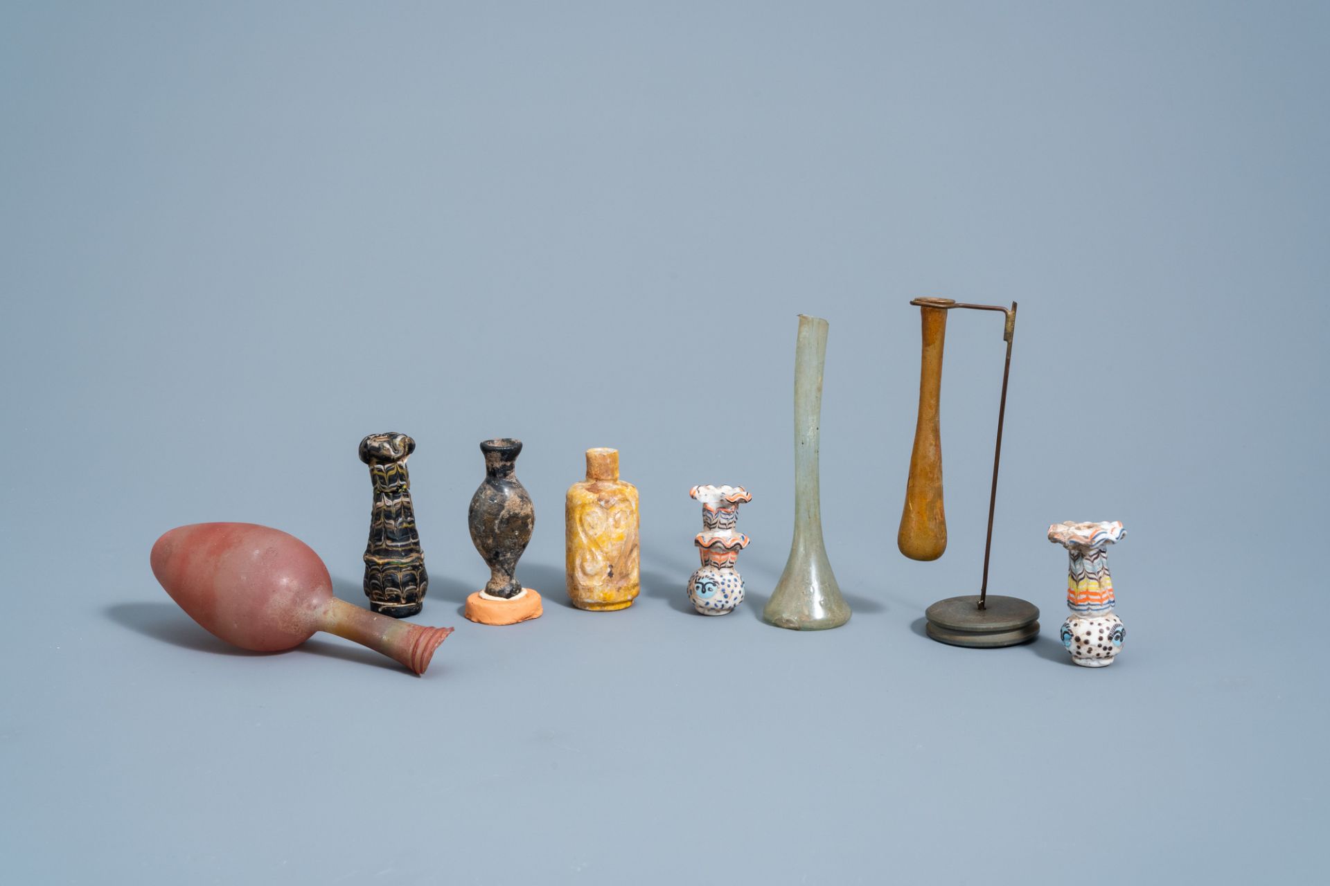 A varied collection of glass bottles and flasks, possibly Roman