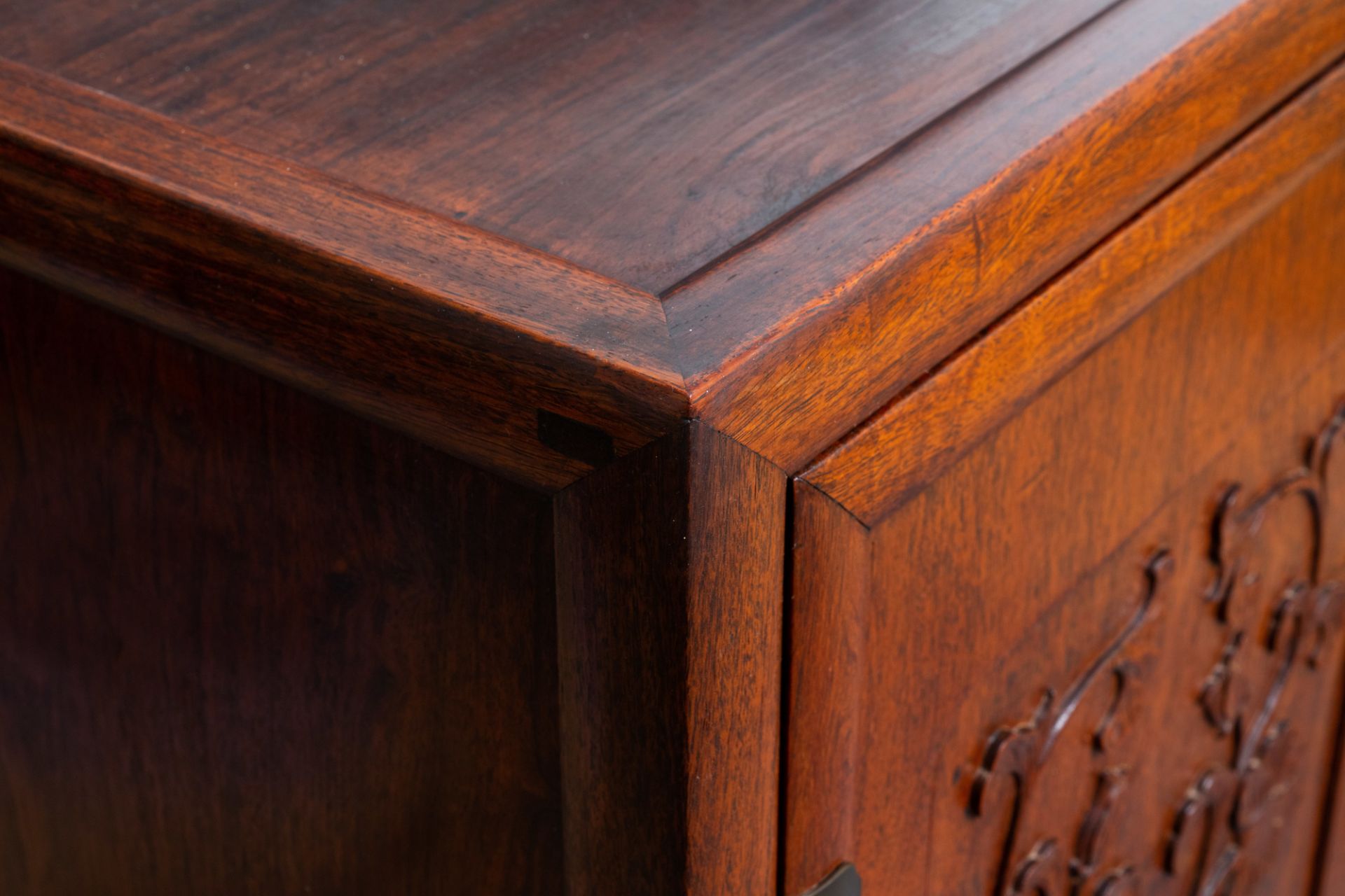 A Chinese wooden two-door cupboard with carved floral panels, 19th C. - Image 2 of 12