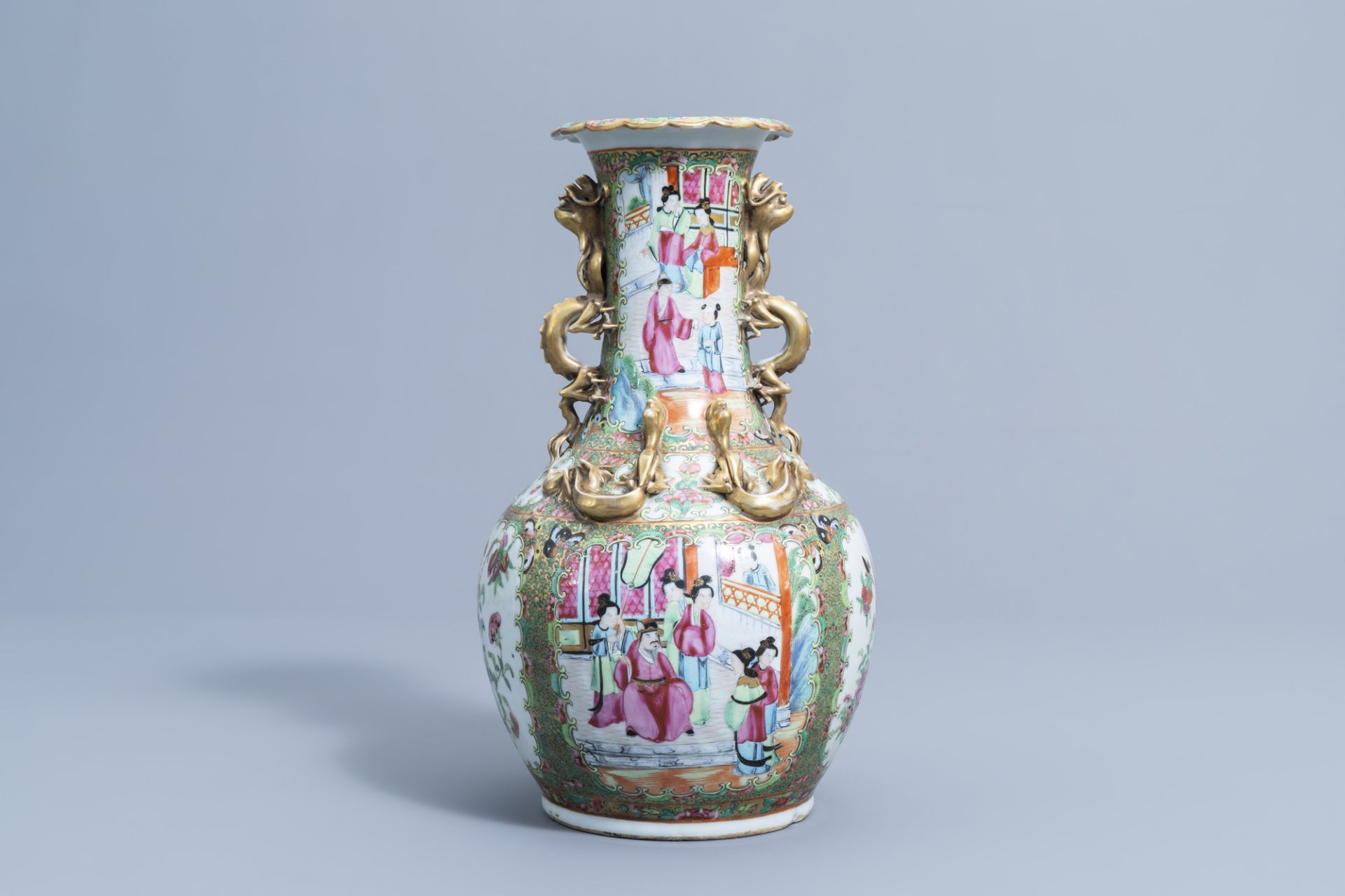 A Chinese Canton famille rose relief decorated 'dragons' bottle vase, 19th C.