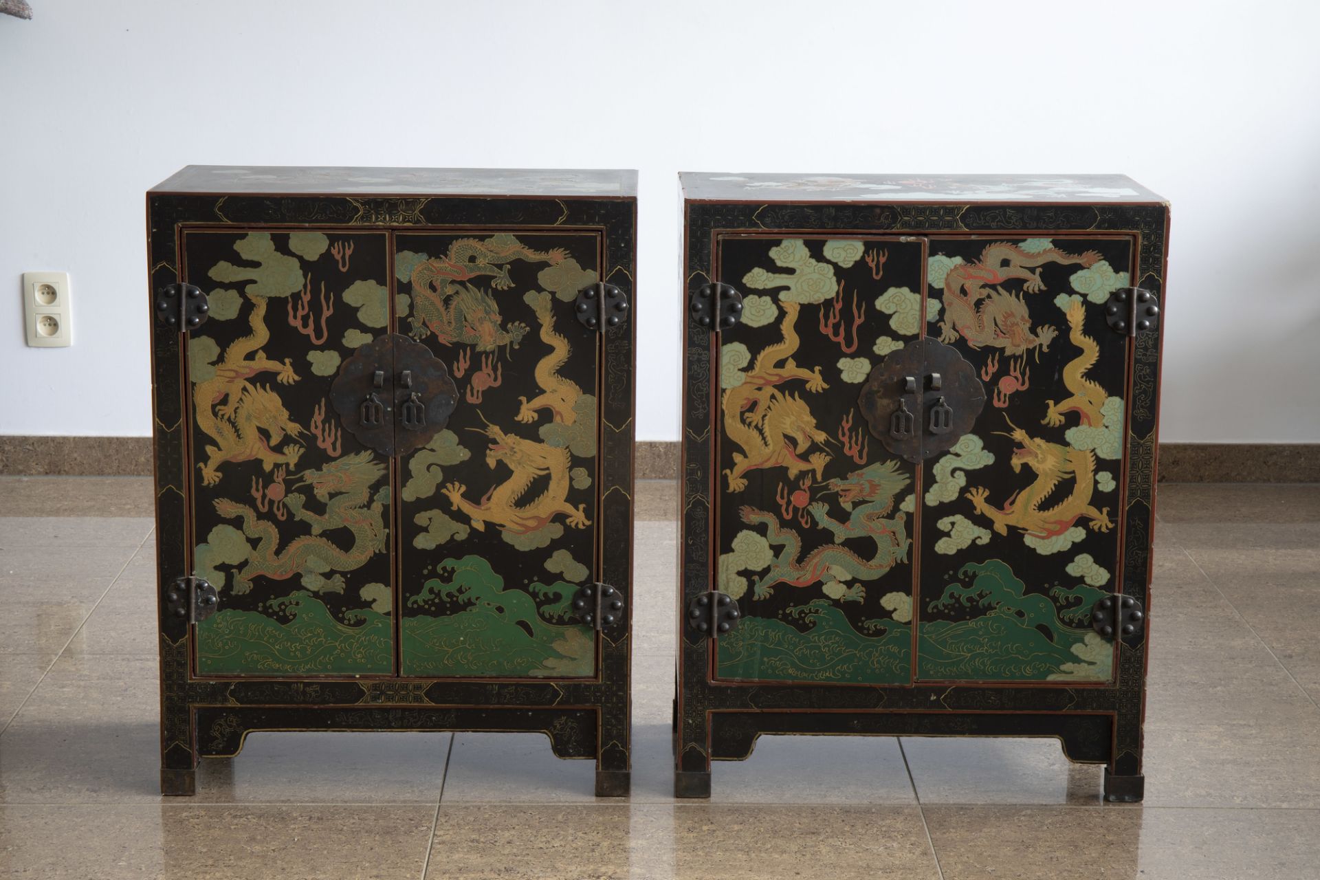 A pair of Chinese black lacquered wooden 'dragons chasing the pearl' two-door cabinets, 20th C. - Image 2 of 7