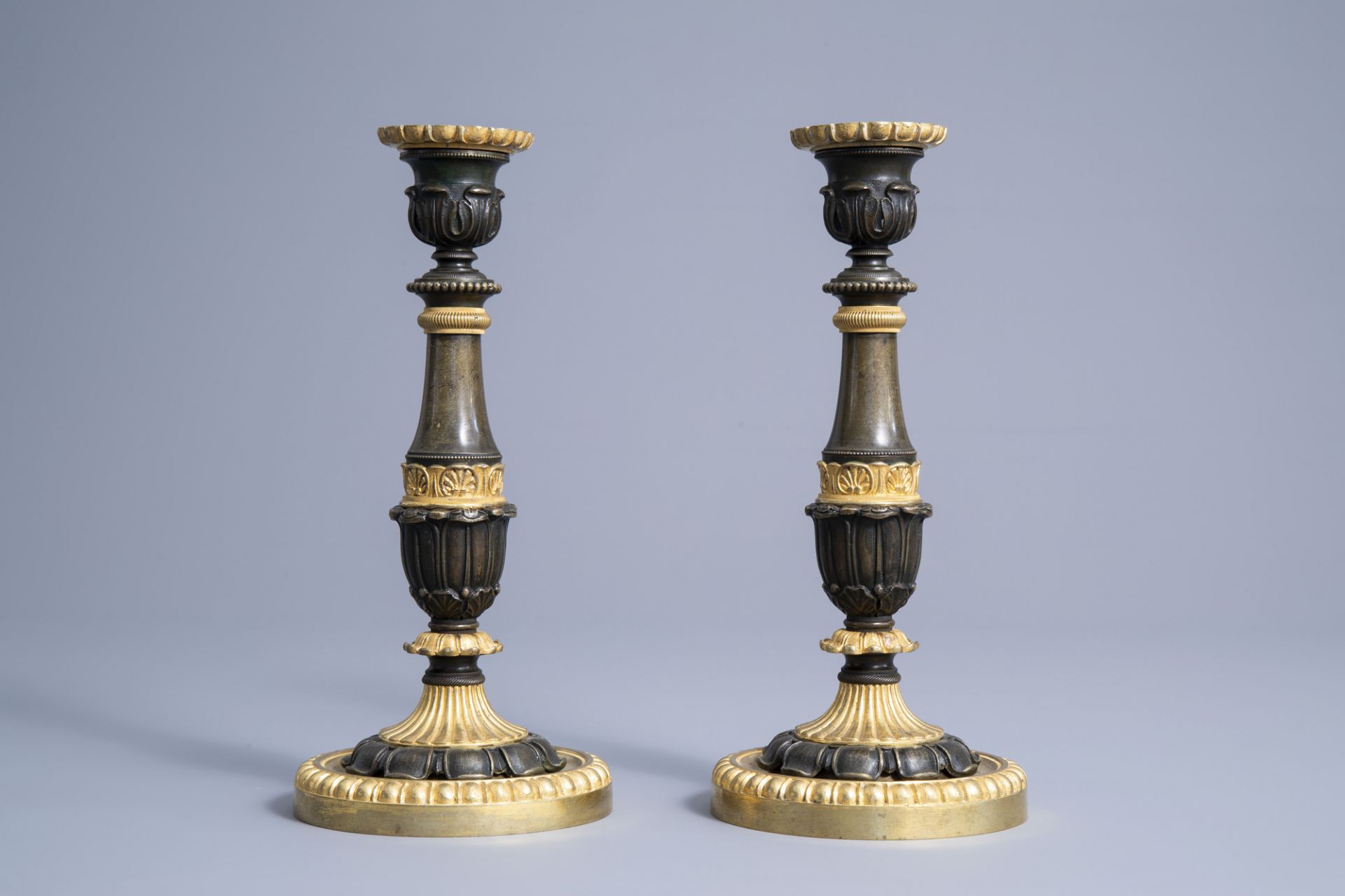 A pair of French gilt and patinated bronze candlesticks with acanthus leaves, 19th C. - Image 3 of 7
