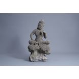 A Chinese carved stone figure of Buddha seated on a rock, Qing