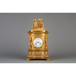 A gilt bronze mantel clock crowned with two putti and a lizard, France, 19th C.