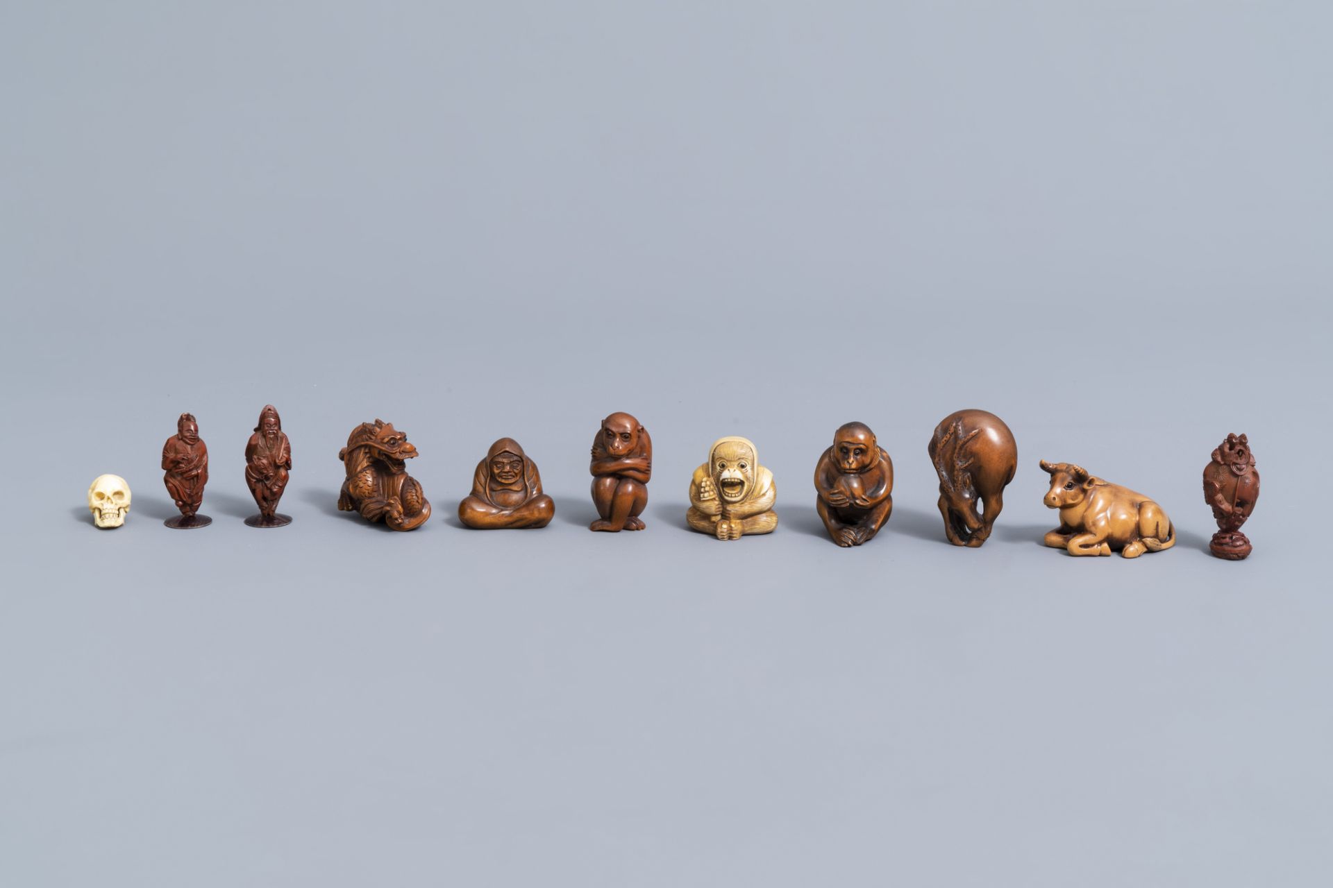 Seven various Japanese ivory and wood netsuke, three Chinese wood figures and a miniature skull, 20t