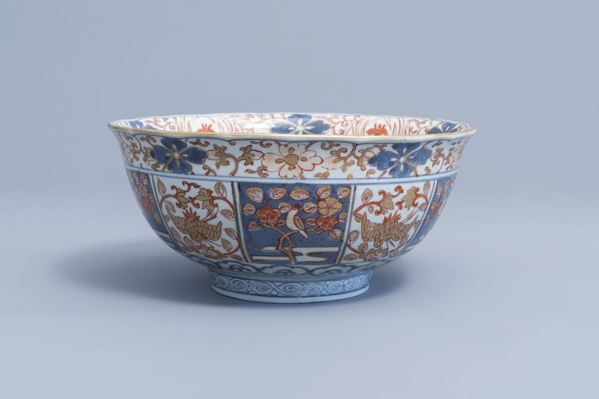 A Japanese Imari bowl with birds among blossoming branches and figures, Edo, 18th C.