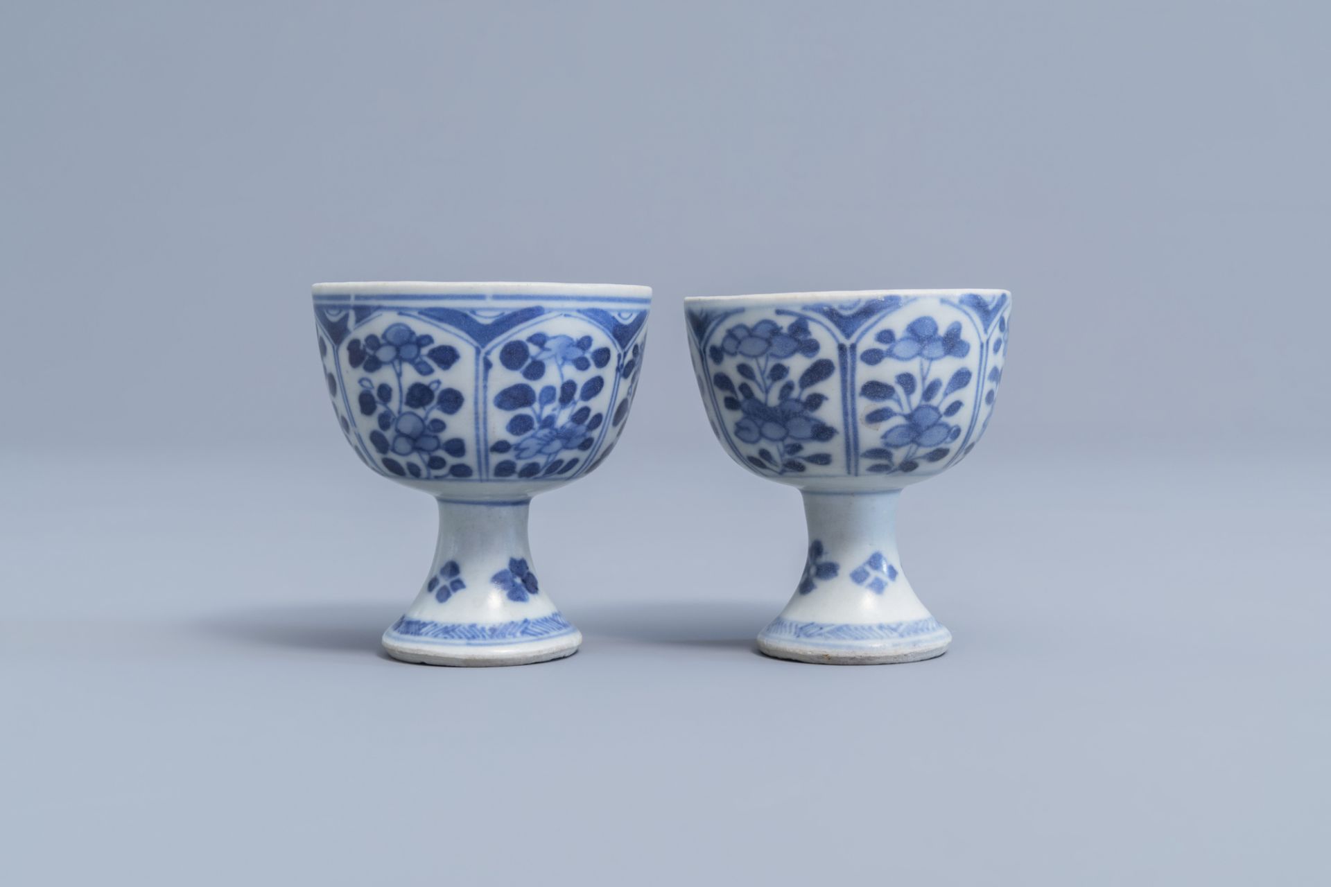 A pair of Chinese blue and white stem cups with floral design and a four-lobed teapot stand, Kangxi - Image 5 of 9