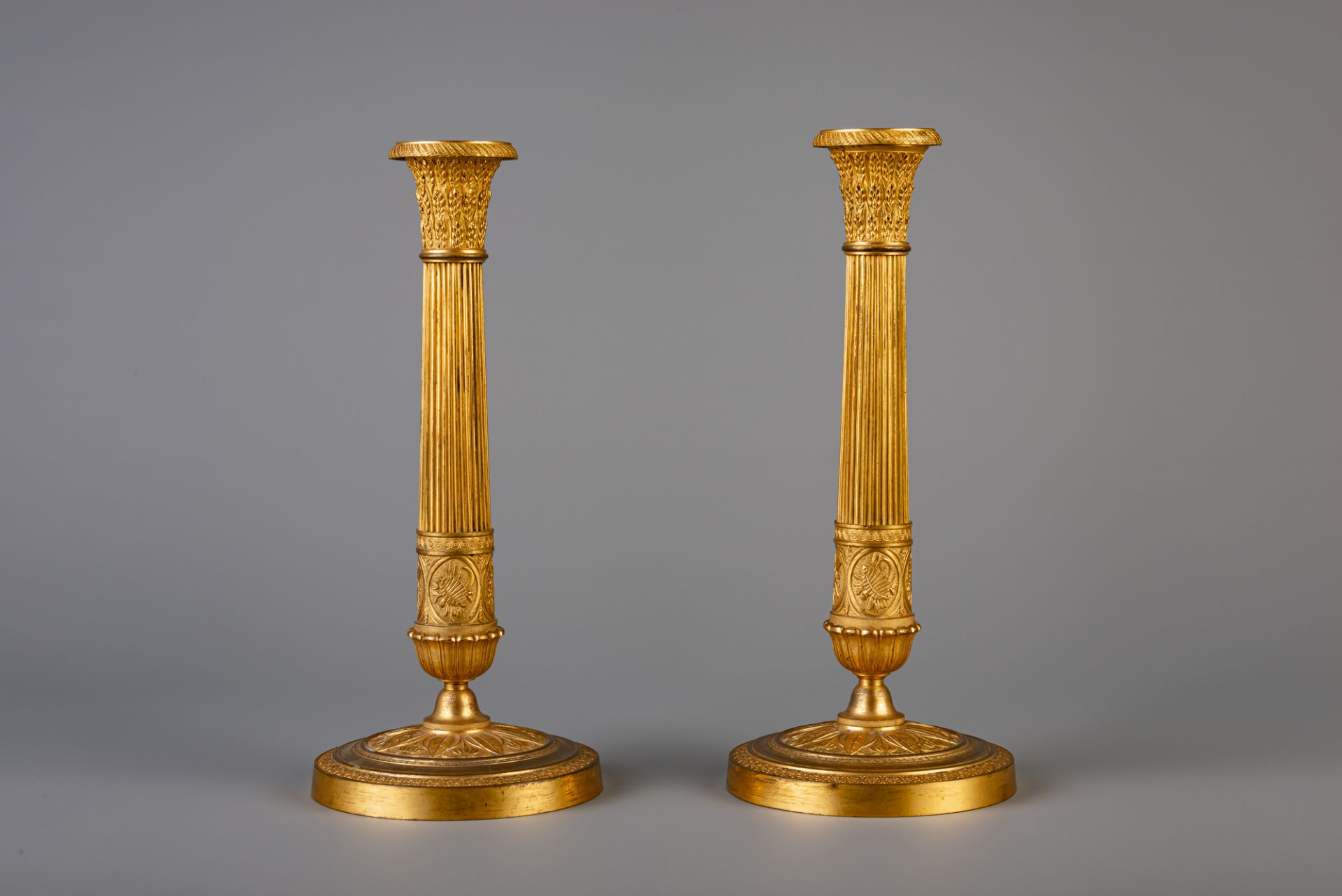 A pair of French Neoclassical gilt bronze candlesticks, 19th C. - Image 4 of 7