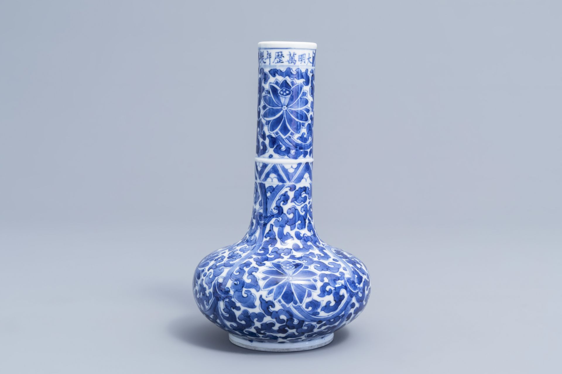 A Chinese blue and white 'lotus scroll' bottle vase, Wanli mark, 19th C. - Image 3 of 6