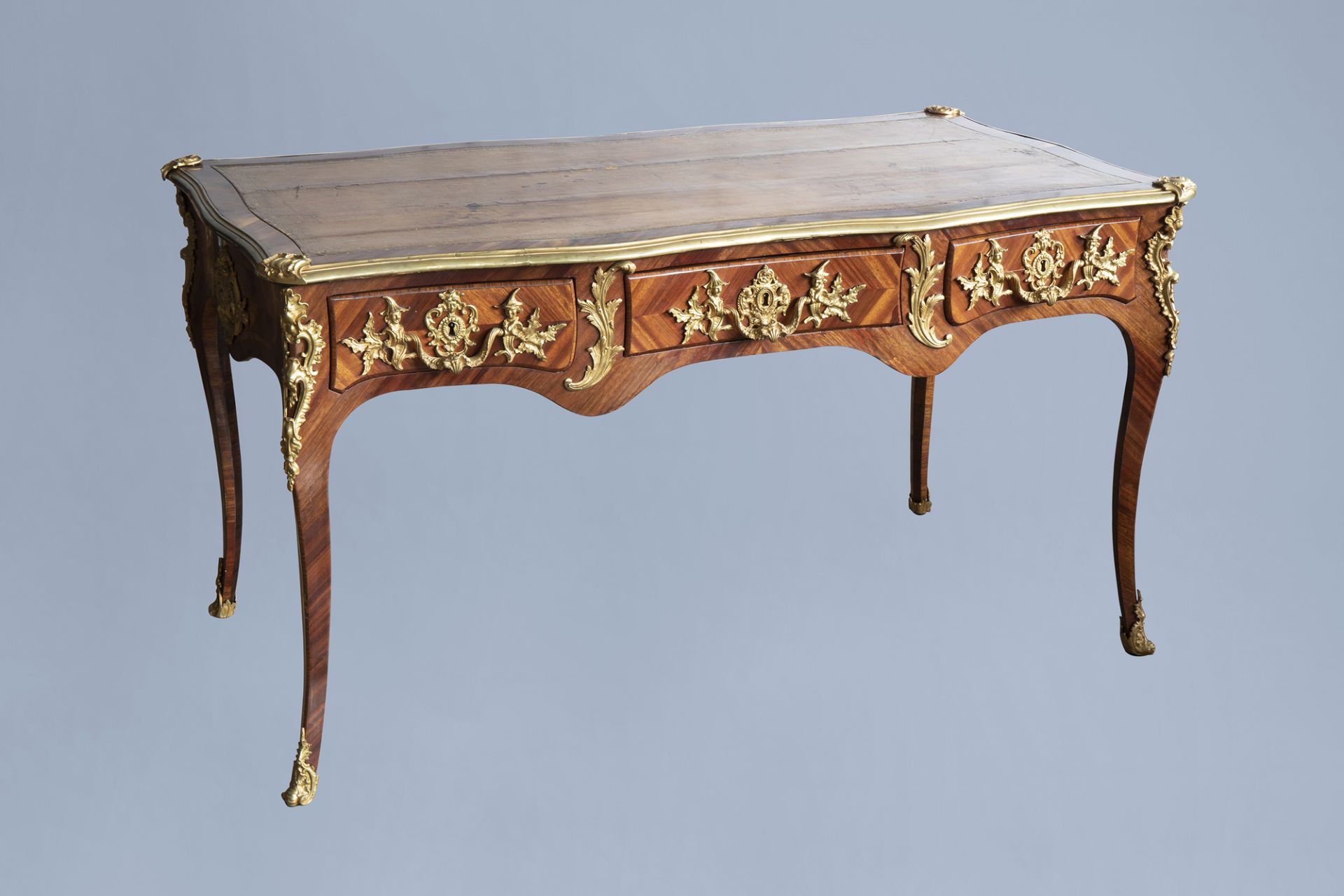 An extremely fine French Louis XV style gilt bronze chinoiserie mounted kingwood bureau plat, mid 18