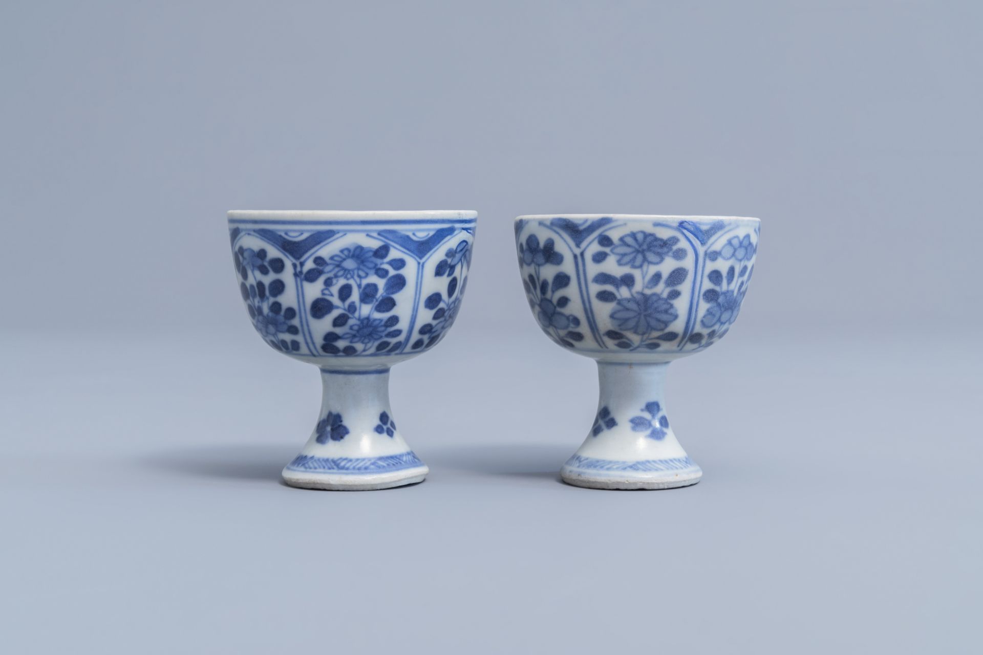 A pair of Chinese blue and white stem cups with floral design and a four-lobed teapot stand, Kangxi - Image 4 of 9