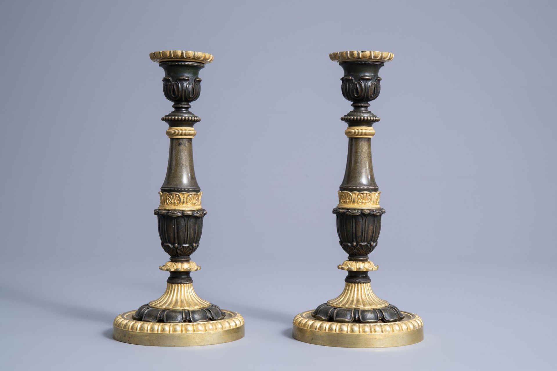 A pair of French gilt and patinated bronze candlesticks with acanthus leaves, 19th C. - Image 4 of 7