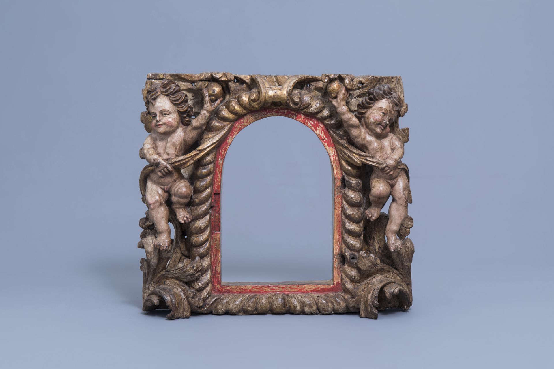 A carved and polychrome and gilt painted wooden tabernacle frame with putti, the Netherlands, 18th C