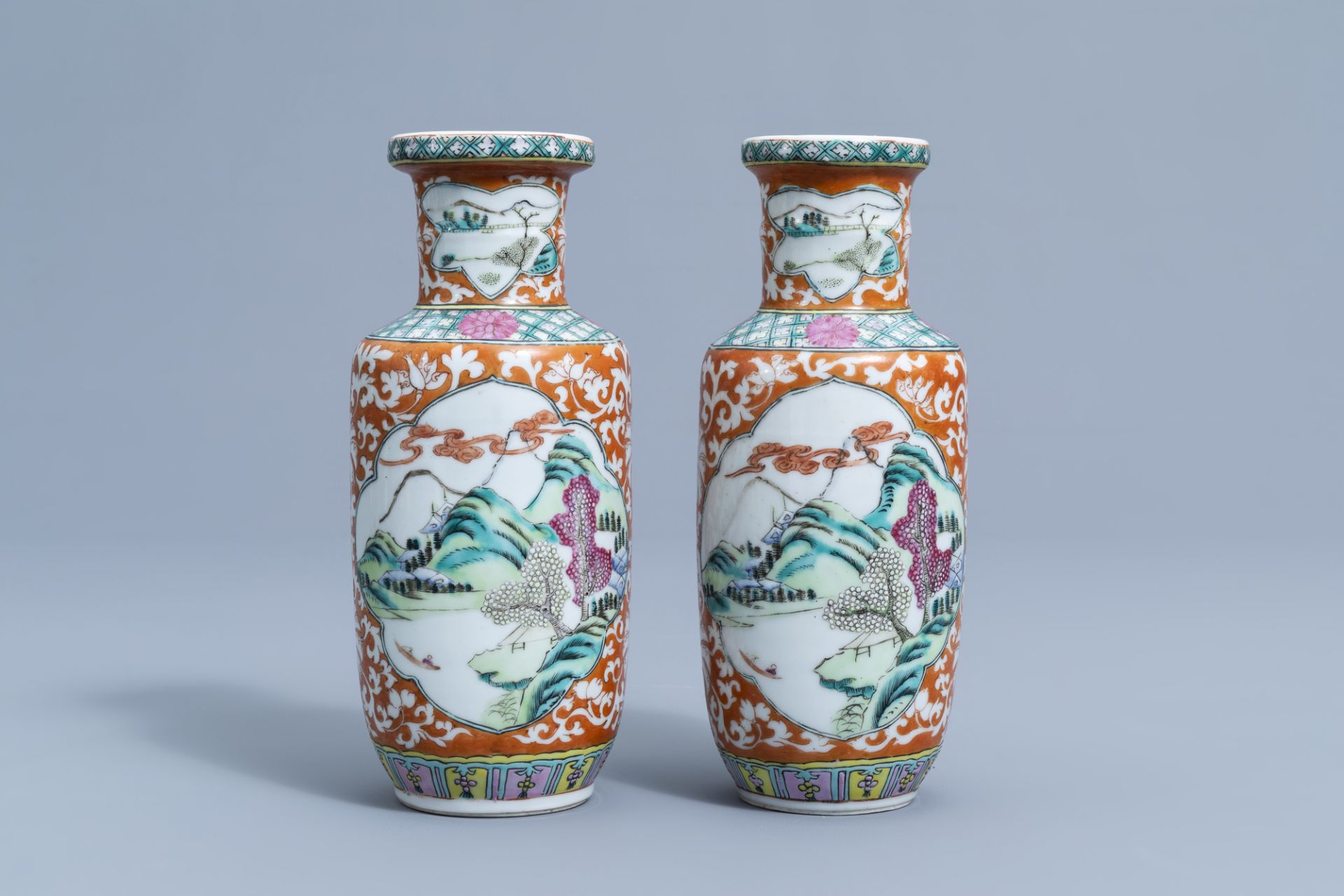 A pair of Chinese famille rose vases with animated river landscapes, 19th C.