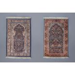 Two Oriental prayer rugs with floral design, silk on cotton, 20th C.