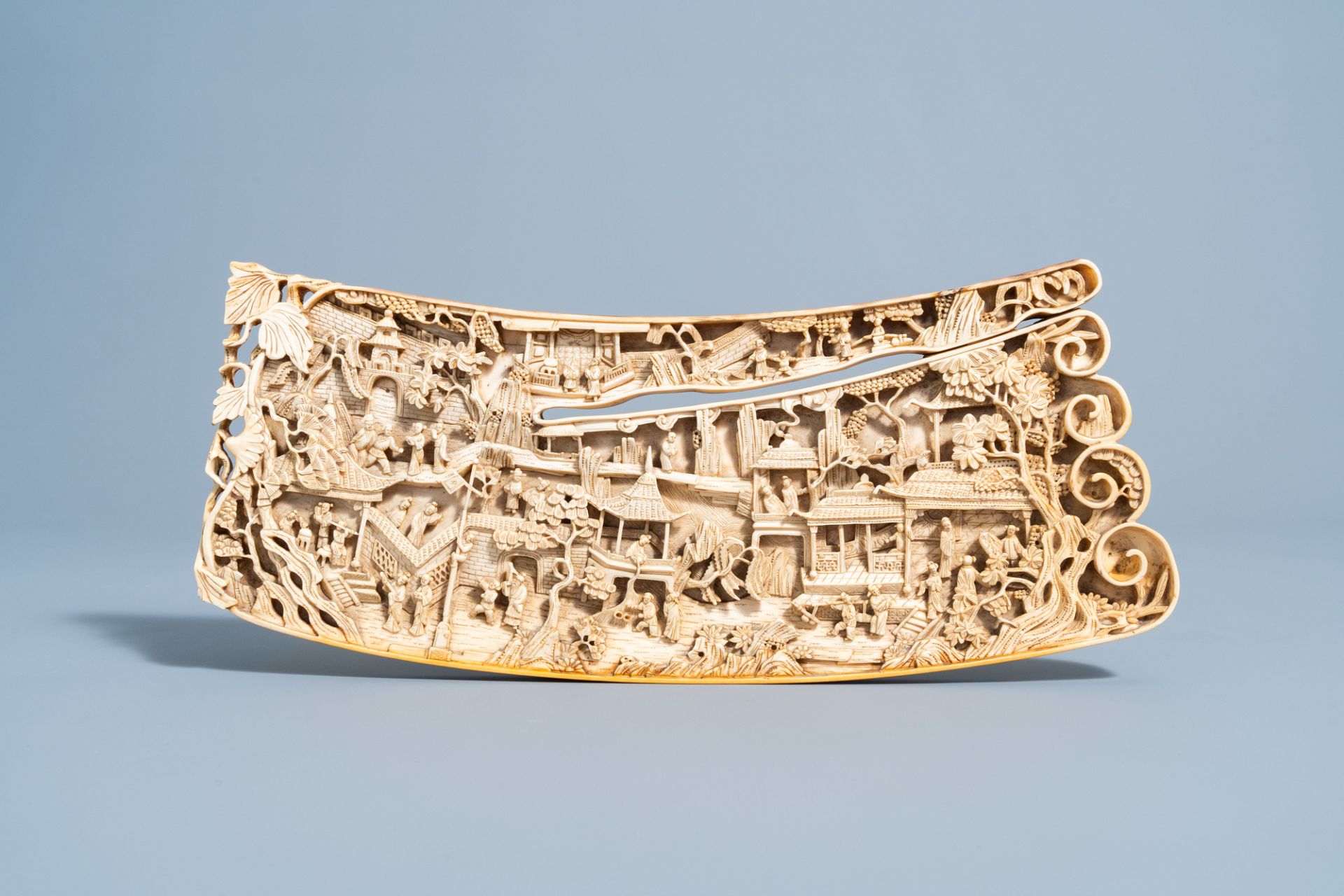 A Chinese richly carved ivory plaque with an animated city view on a wooden base, Canton, 19th C. - Image 8 of 15