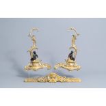 A pair of French Louis XV style patinated and gilt bronze andirons with putti, 19th C.