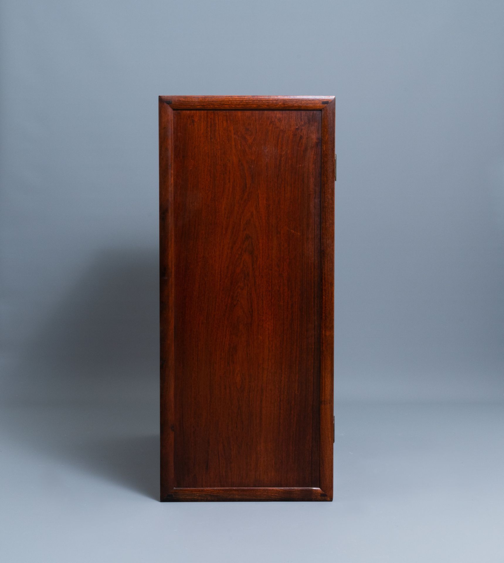 A Chinese wooden two-door cupboard with carved floral panels, 19th C. - Image 6 of 12