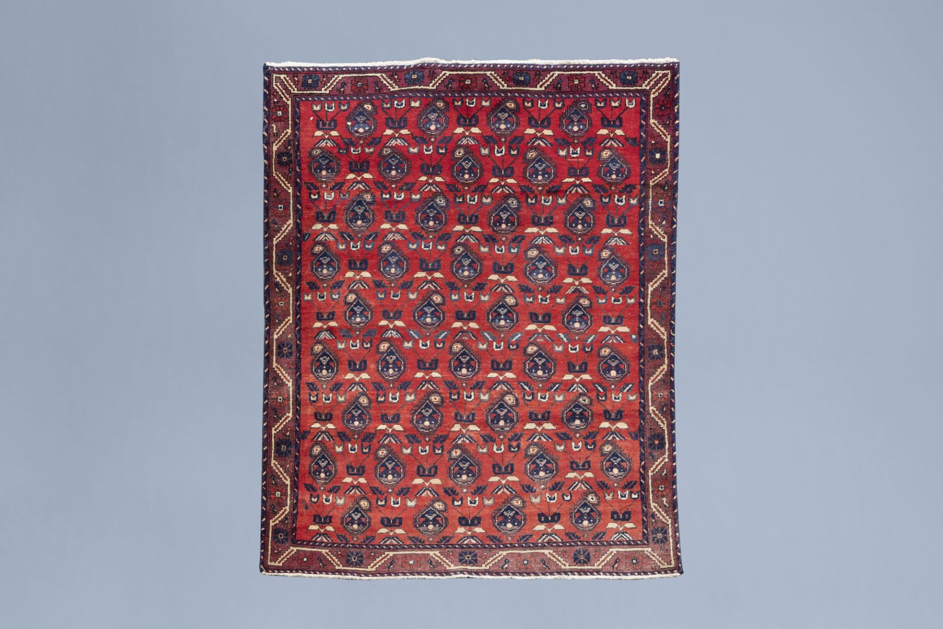 An Oriental Hamadan Boteh rug with floral design, wool on cotton, Iran, 20th C.