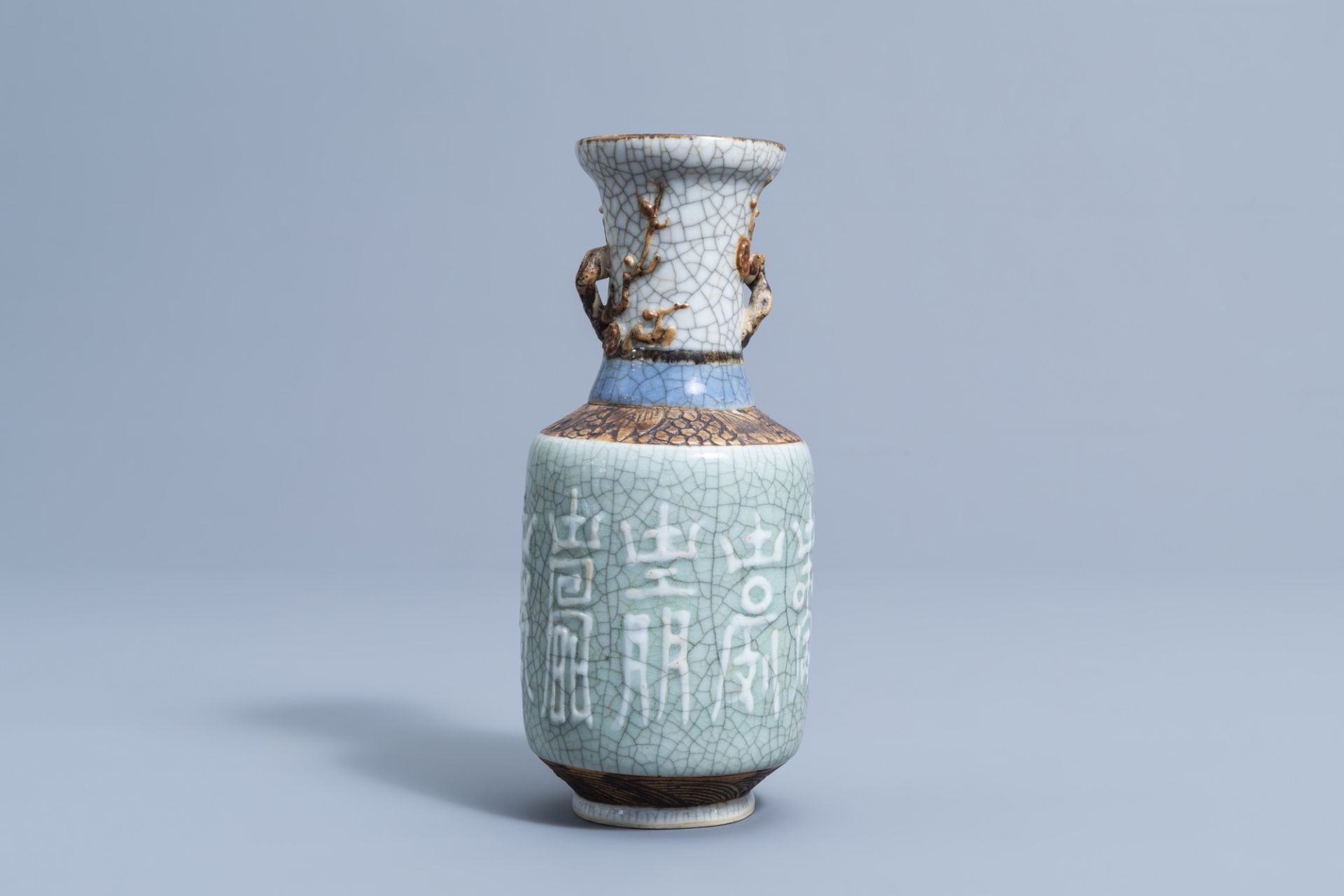 A Chinese Nanking crackle glazed celadon vase with relief design, 19th C.