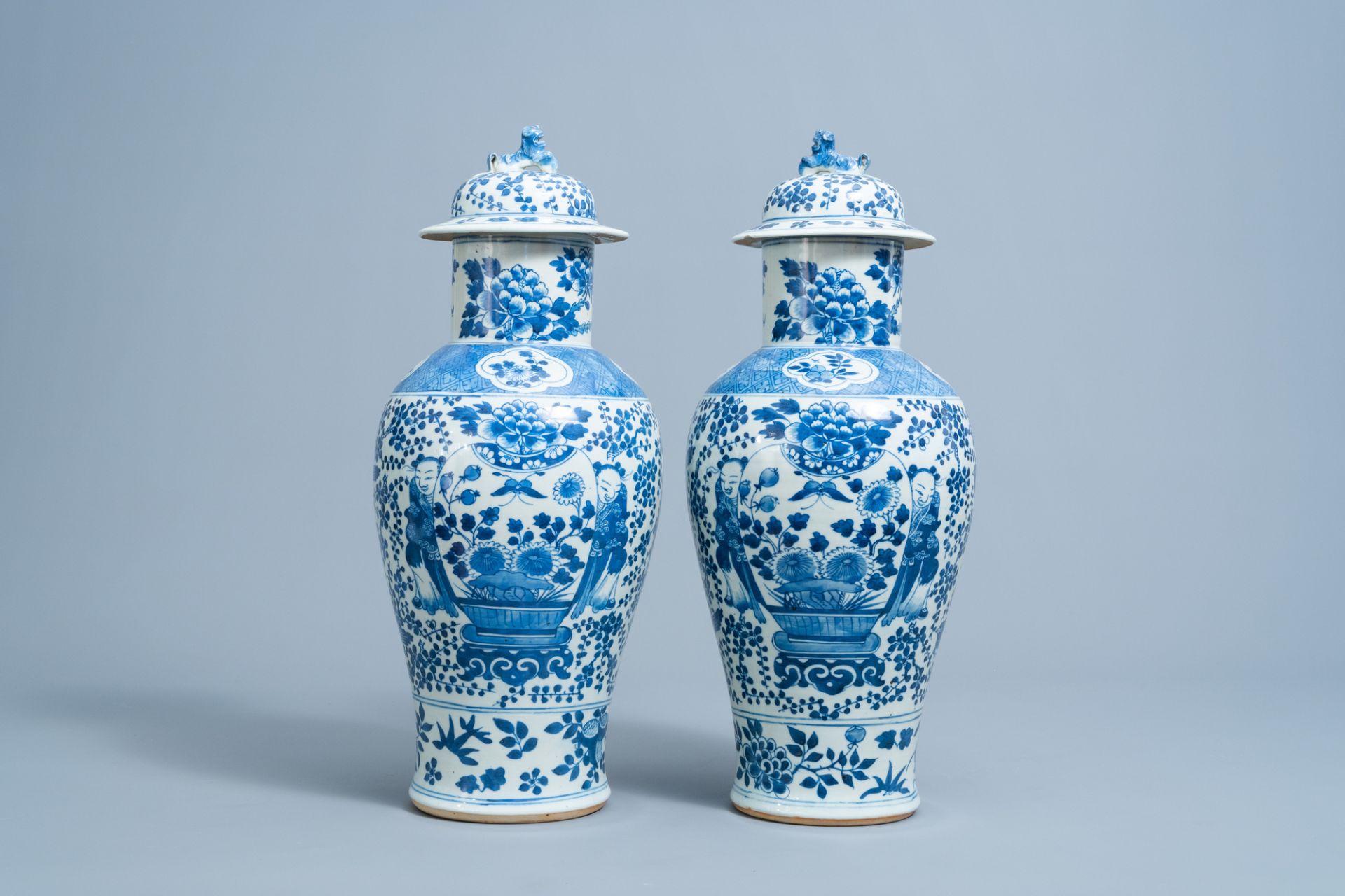 A pair of Chinese blue and white vases and covers with boys and antiquities, 19th C.