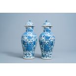 A pair of Chinese blue and white vases and covers with boys and antiquities, 19th C.
