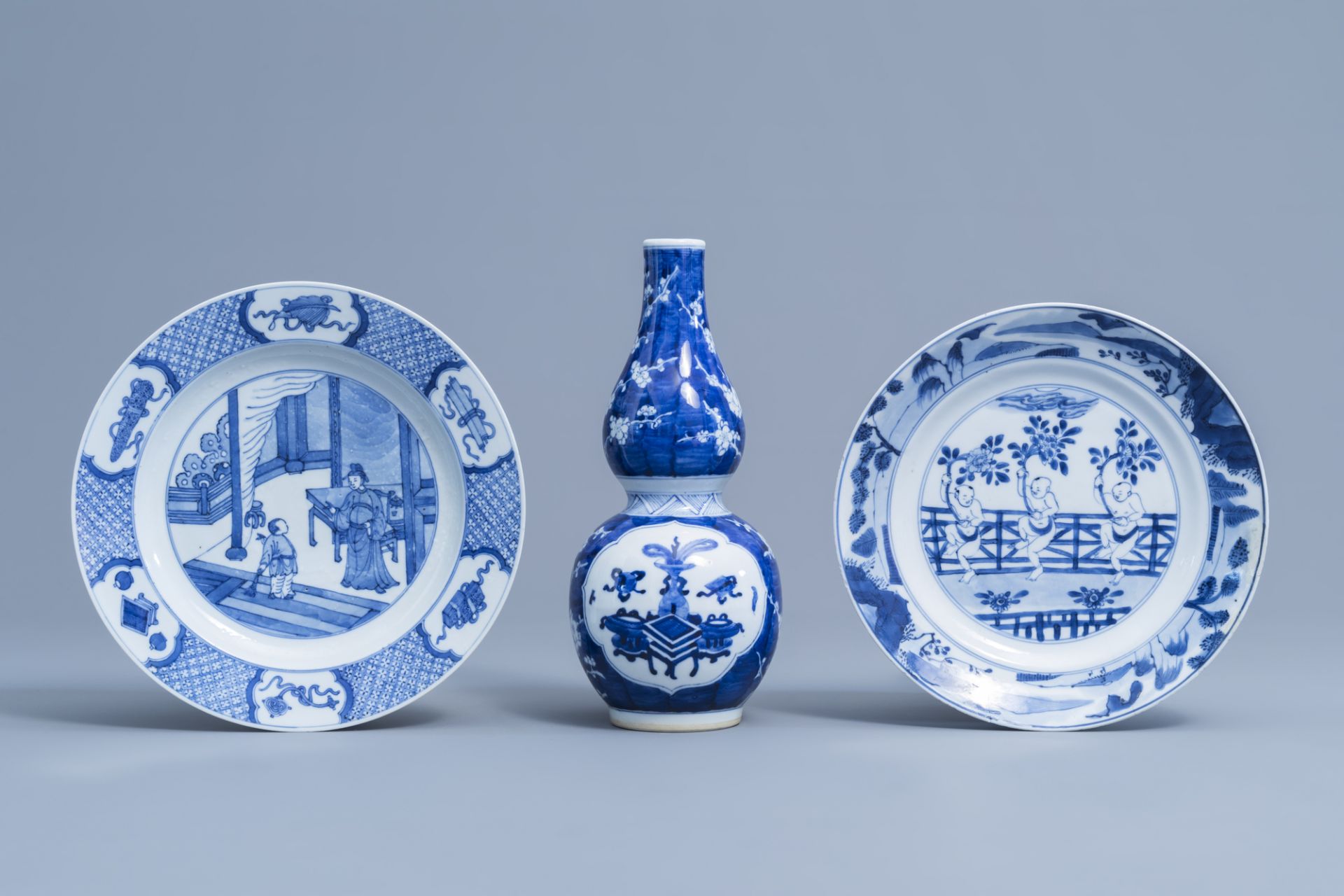 A Chinese blue and white double gourd vase with antiquities design and two plates with figurative de