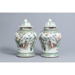 A pair of Chinese famille verte vases and covers with ladies and children on a terrace, 19th C.