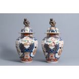 A pair of French Samson Imari style vases and covers with birds among flower branches and figures, 1