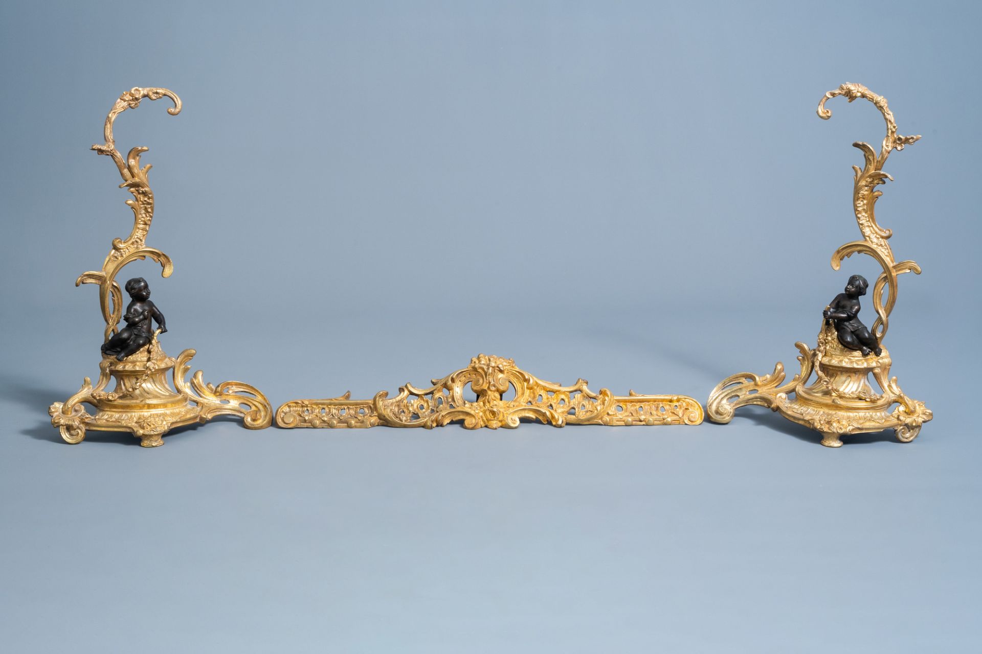 A pair of French Louis XV style patinated and gilt bronze andirons with putti, 19th C. - Image 14 of 15