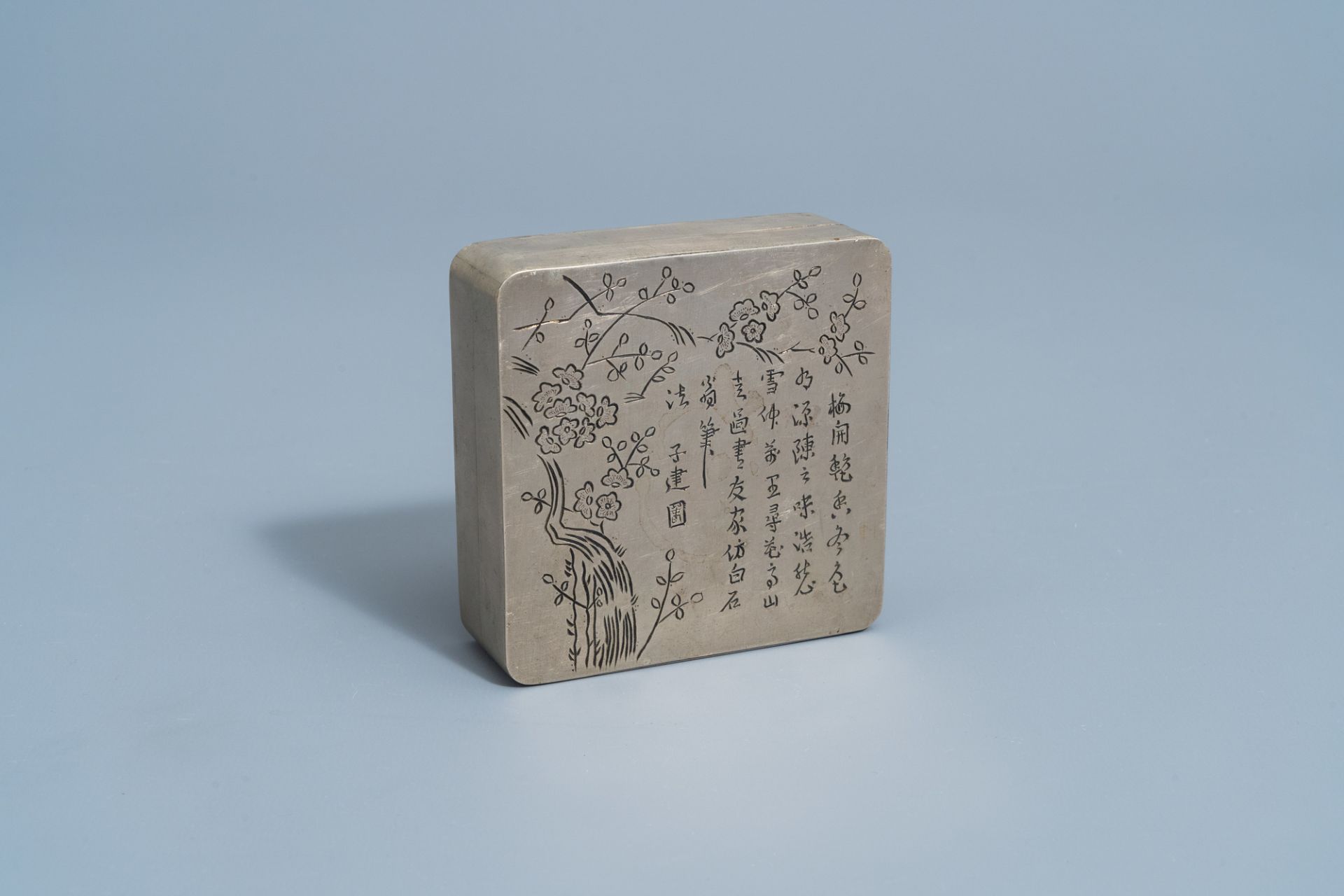 A Chinese square paktong metal scholar's ink box with calligraphy and floral design, marked, 20th C.