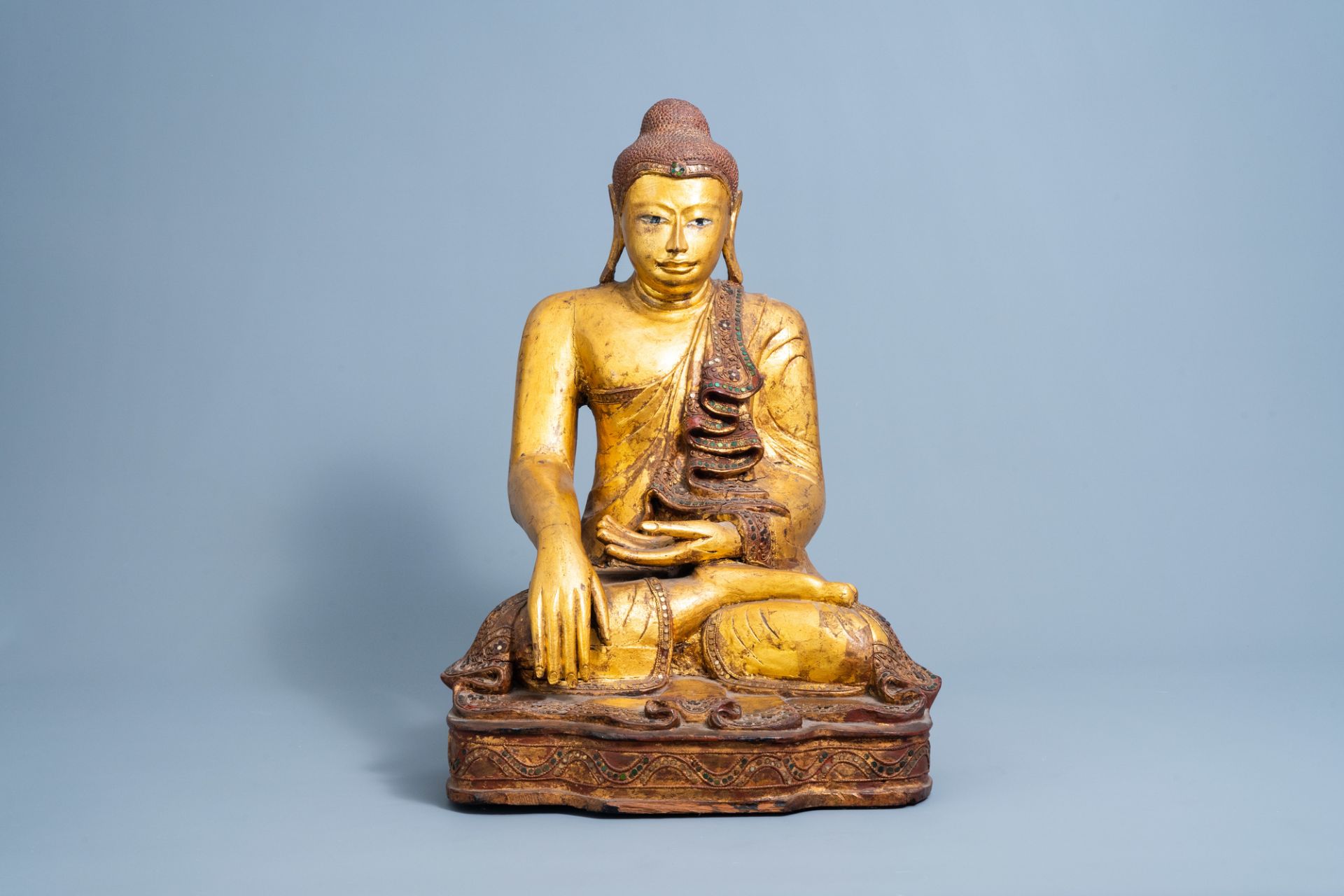 A tall inlaid gilt wood figure of a seated Buddha, Burma or Thailand, 19th/20th C.