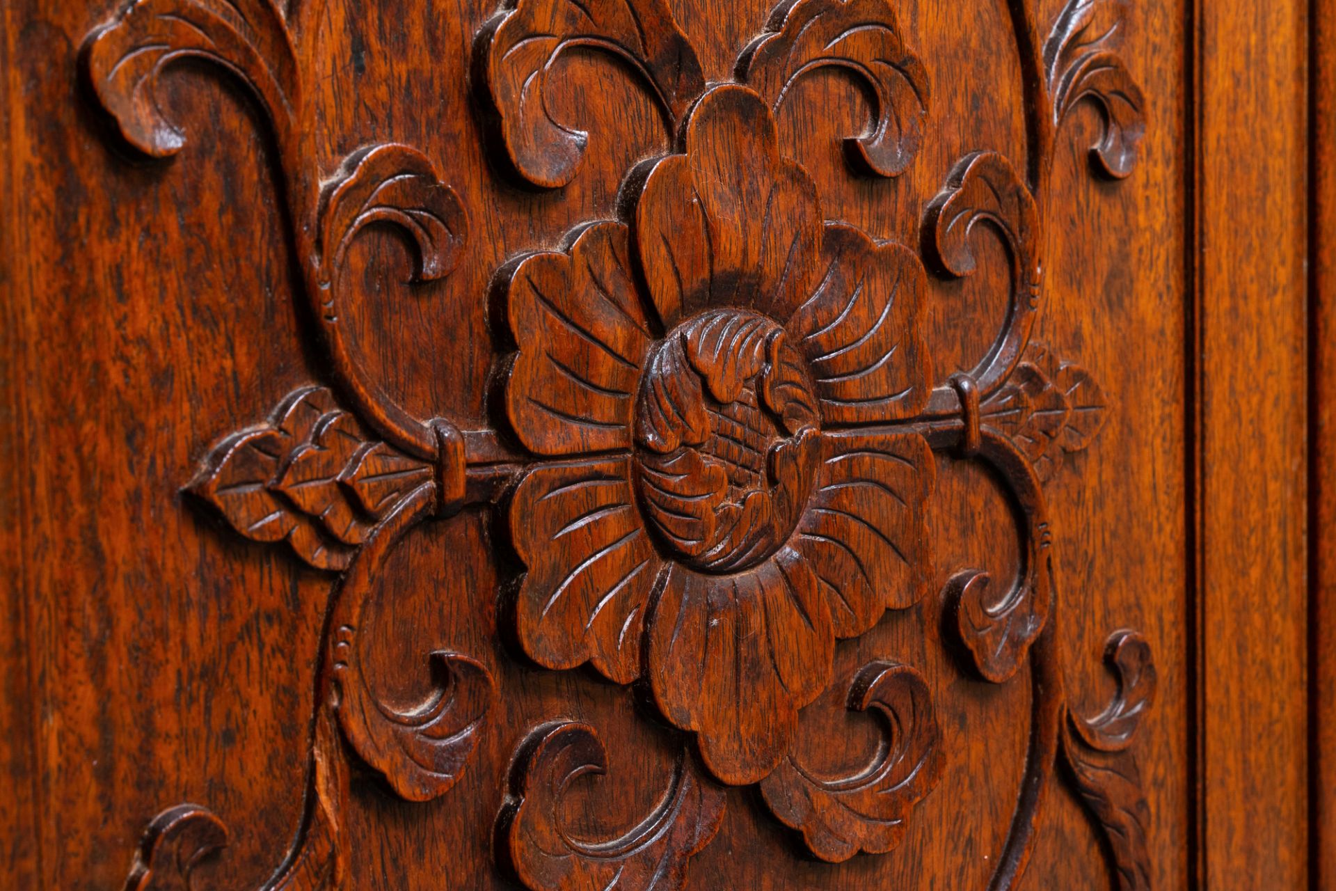 A Chinese wooden two-door cupboard with carved floral panels, 19th C. - Image 4 of 12
