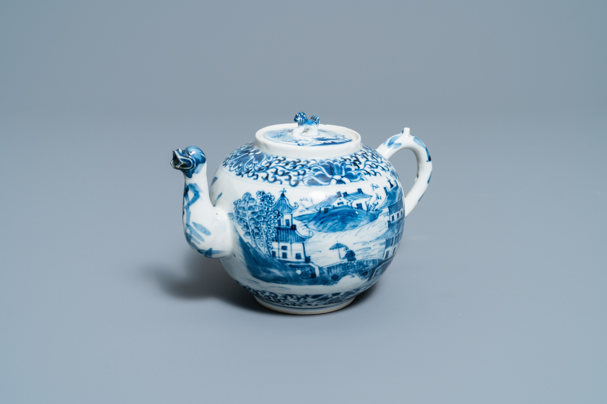 A Chinese blue and white teapot and cover with figures in a landscape, 19th C.