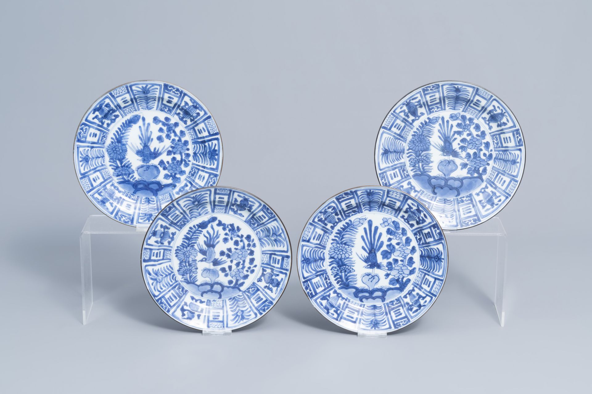 Four Chinese blue and white plates with a bird among blossoming branches, Kangxi