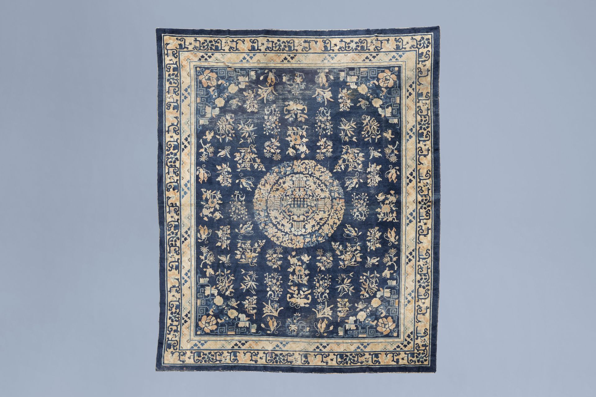 A Chinese Baotou rug with floral design, wool on cotton, first half of the 20th C.