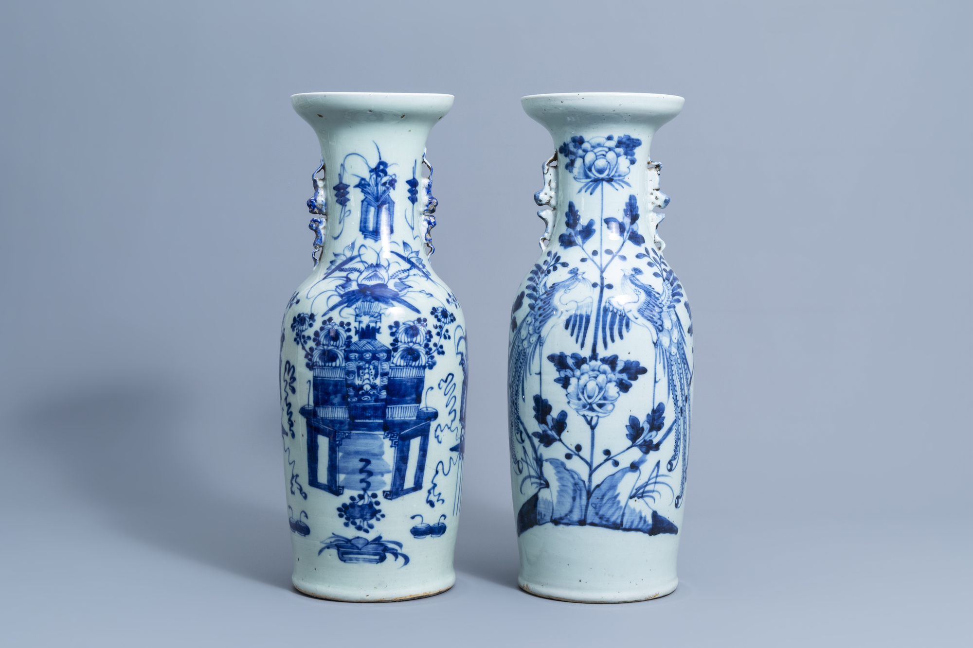 Two Chinese blue and white celadon ground vases with antiquities and phoenixes, 19th/20th C.